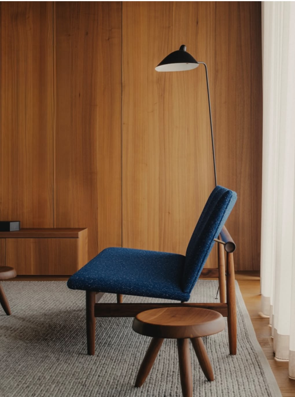 Warm wood panel with an indigo chair